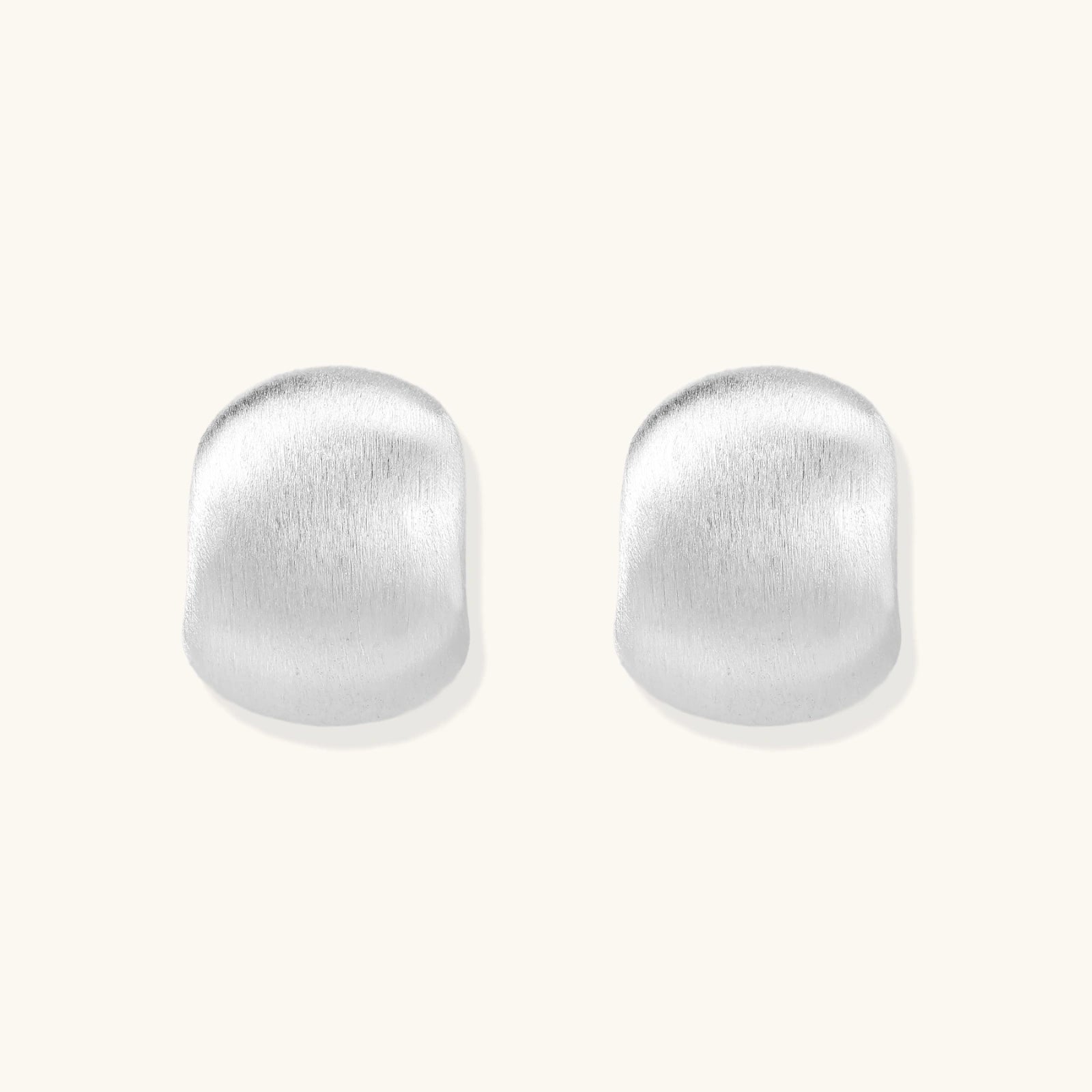 Brushed sterling silver cushion-shaped stud earrings with matte finish on white background