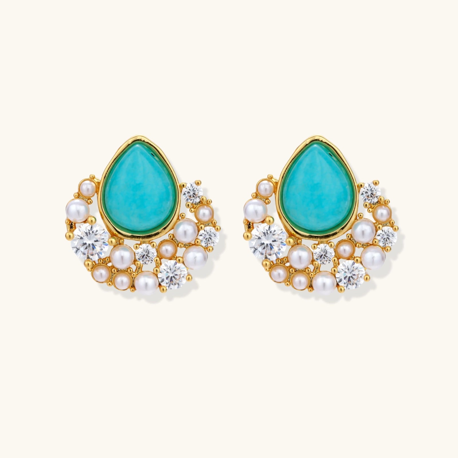 Gold-plated cluster earrings with teardrop turquoise stones surrounded by white pearls and clear crystals