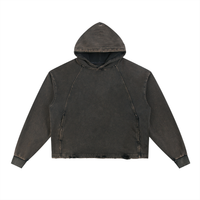 Faded black hoodie with a worn, distressed look, featuring long sleeves, a hood, and visible seam detailing on a plain white background.